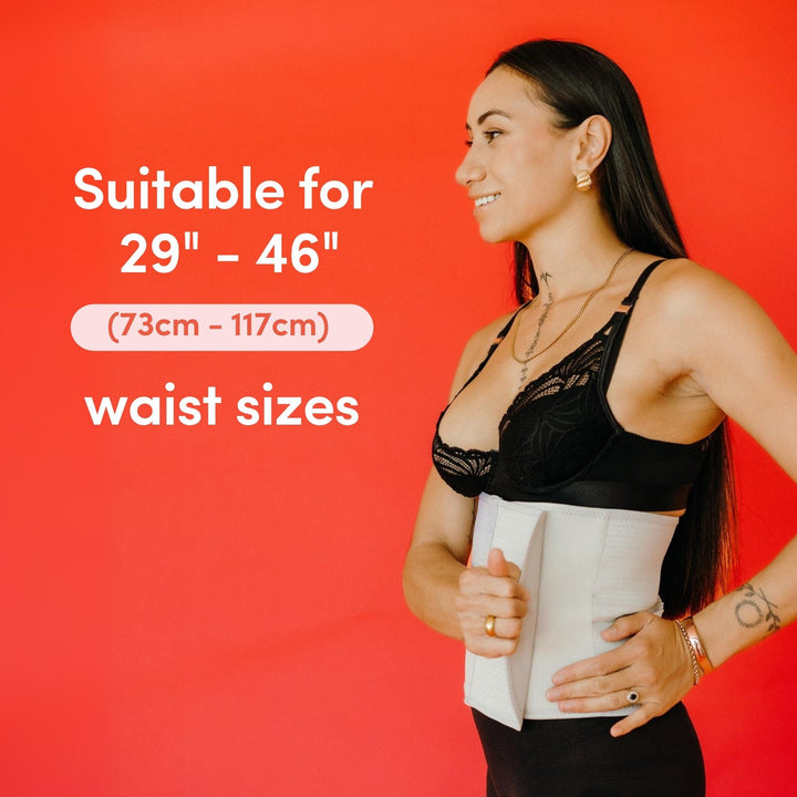 Woman wrapping a grey abdominal support binder around her waist with text about waist size suitability on a red background