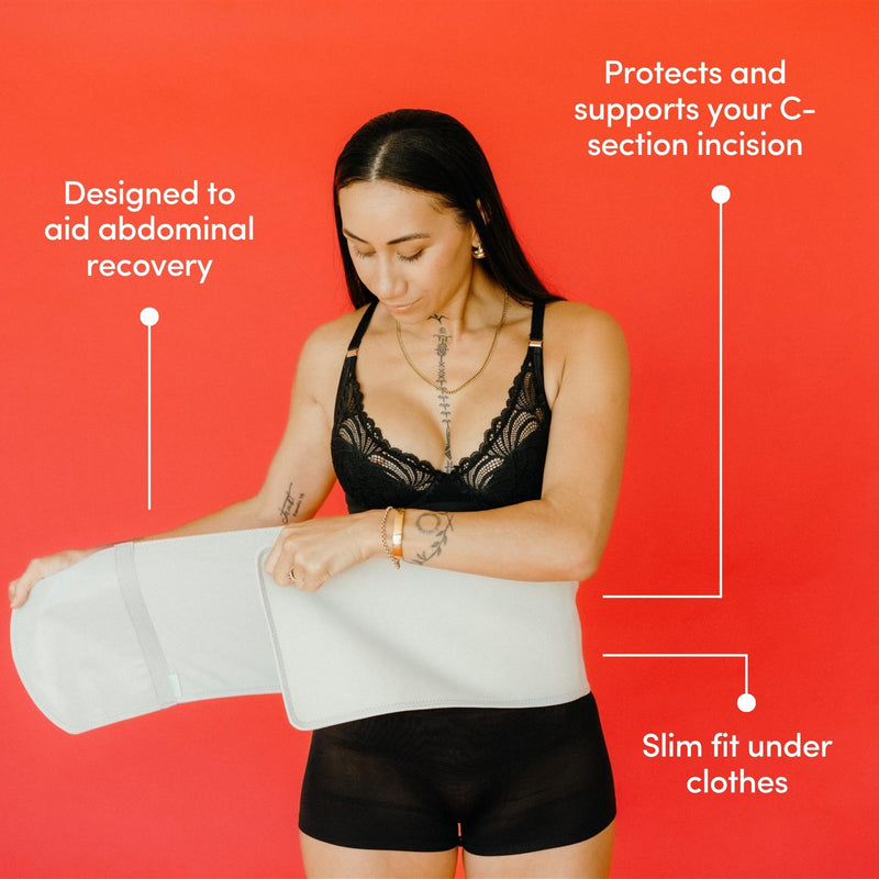Woman wearing a grey abdominal support binder against a red background with text highlighting its features.