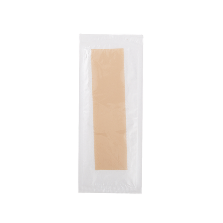 Beige c-section scar patch in a clear plastic packaging on a white background