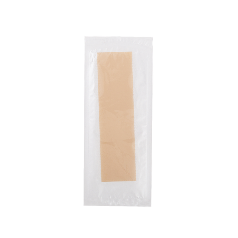 Beige c-section scar patch in a clear plastic packaging on a white background