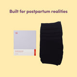 Black disposable postpartum briefs with packaging text saying 'Built for postpartum realities' on a beige background