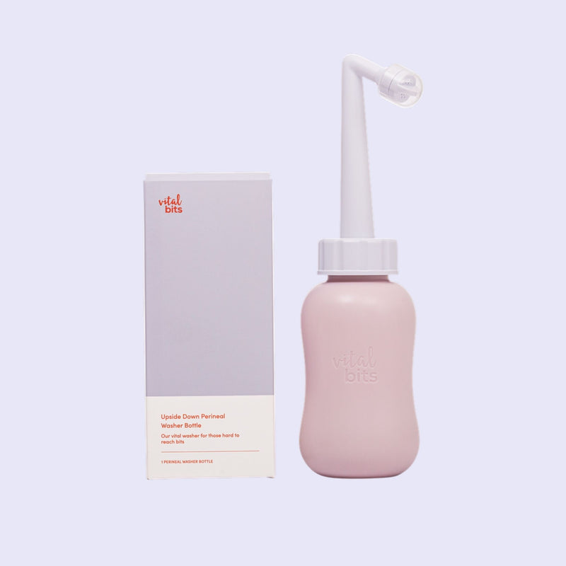 A Vital Bits peri bottle with packaging on a light purple background