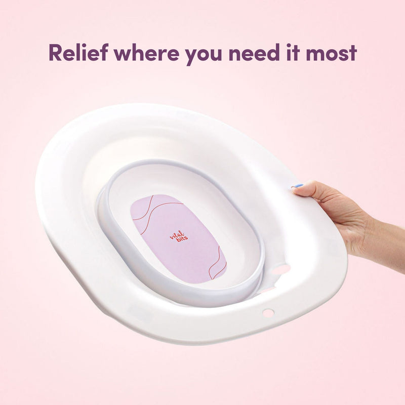 A Vital Bits Sitz Bath held by a hand on a pink background with text 'Relief where you need it most'.